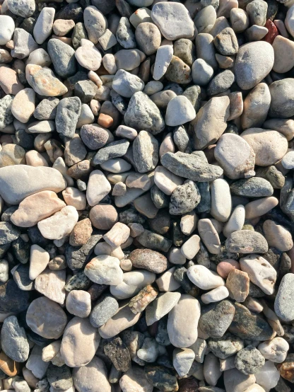 a pile of rocks sitting on top of a beach, highly detailed # no filter, overhead shot, close-up photograph, 10k