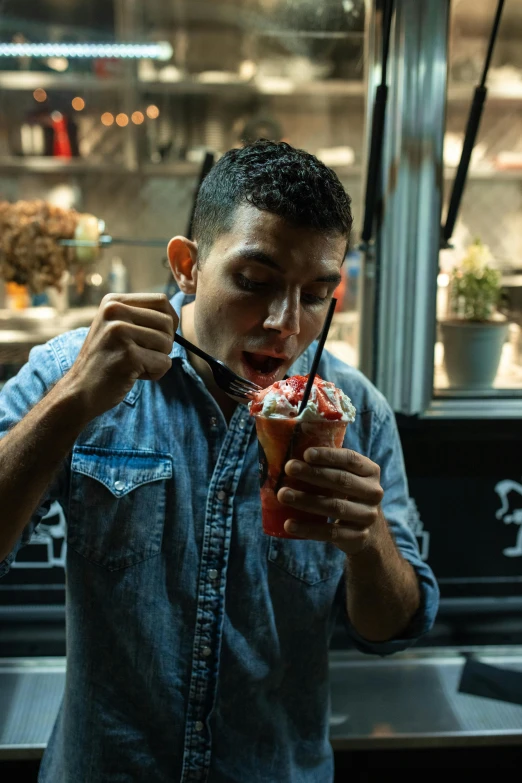 a man standing in front of a counter holding a drink, inspired by Eddie Mendoza, pexels contest winner, eating ice cream, profile image, thumbnail, jakarta