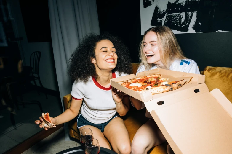 two women sitting on a couch eating pizza, by Niko Henrichon, pexels contest winner, pizza box, over the shoulder, college party, profile image