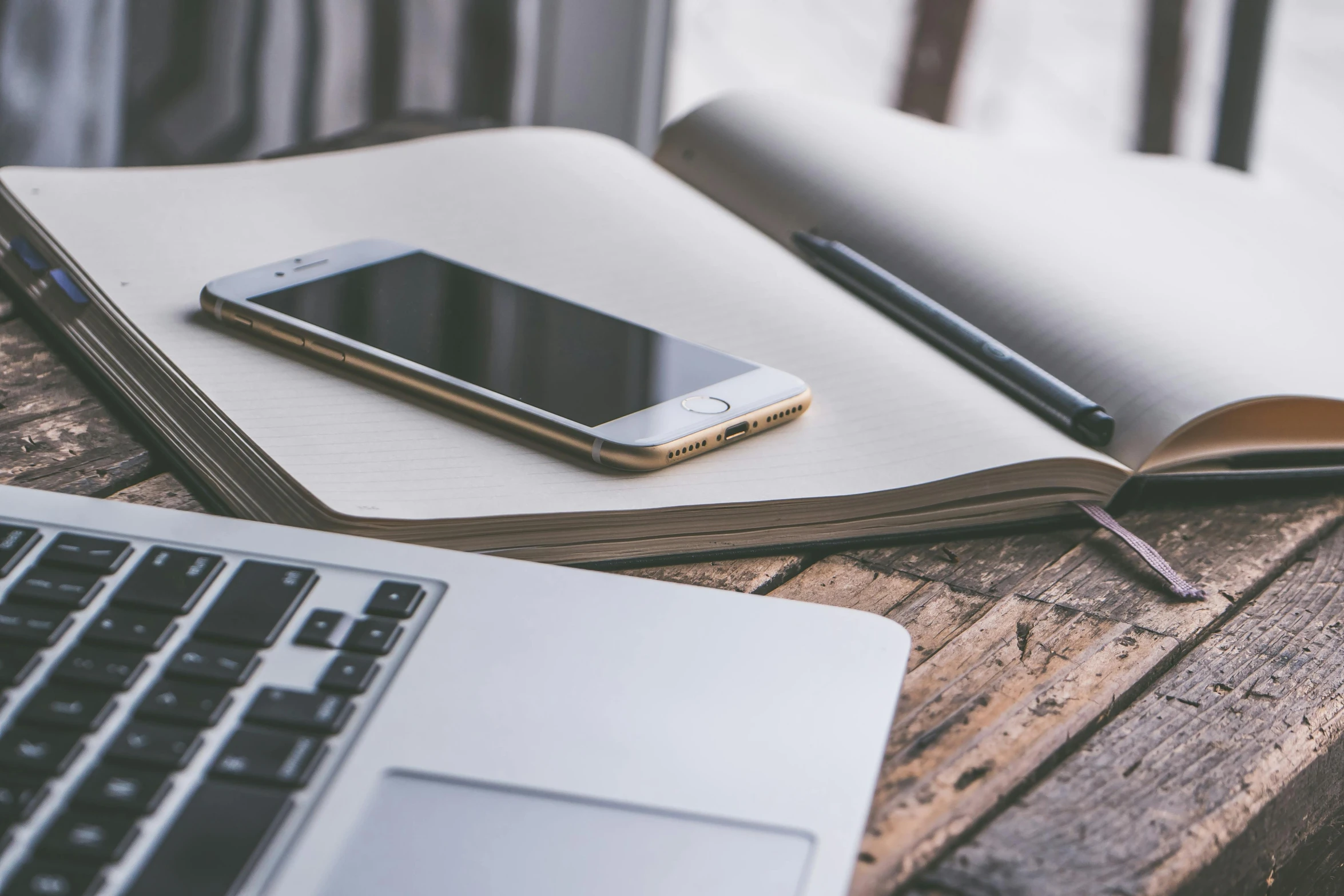 a laptop computer sitting on top of a wooden table, trending on pexels, phone background, weathered pages, brown, iphone