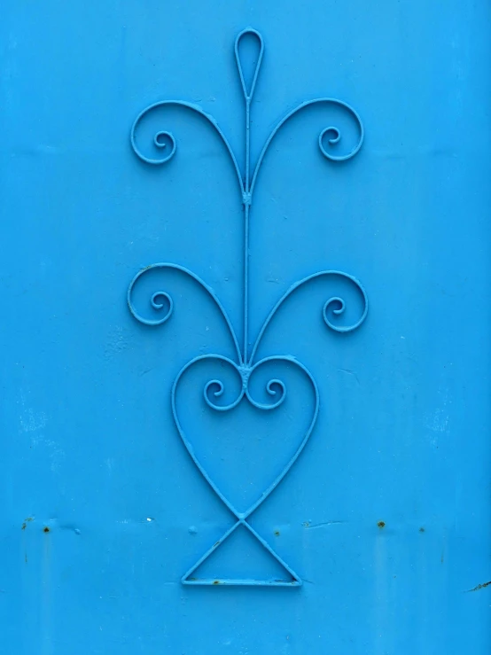 a blue door with a decorative design on it, inspired by Lucio Fontana, unsplash, hearts symbol, wrought iron, ilustration, metal art