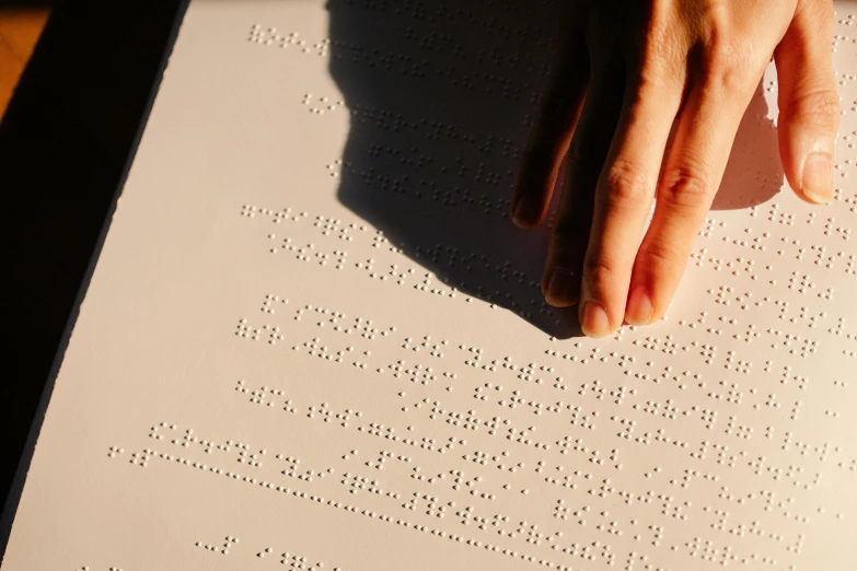 a close up of a person's hand on a piece of paper, by Jan Rustem, unsplash, ascii art, a very macular woman in white, perfect crisp sunlight, educational, multiple stories