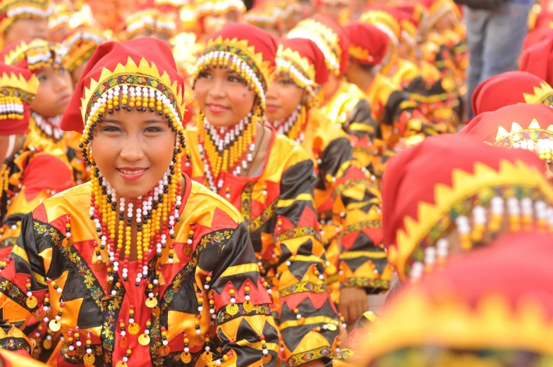 a group of women dressed in red and yellow, by Bernardino Mei, pexels contest winner, dau-al-set, wearing a dress made of beads, philippines, square, brown