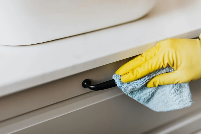 a person in yellow gloves cleaning a sink, a detailed painting, unsplash, plasticien, profile image, made of brushed steel, detail and care, yellow and black trim