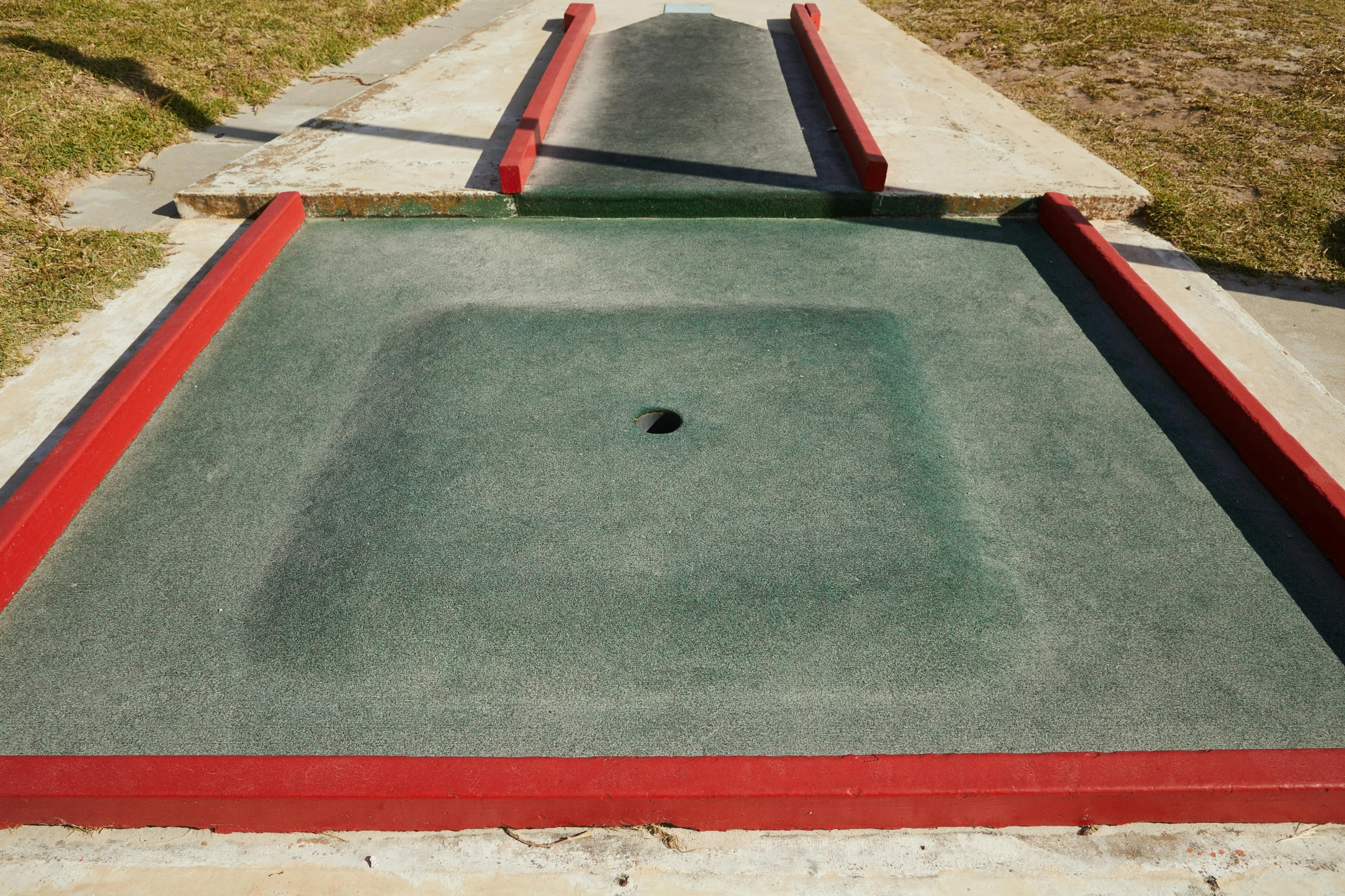 a miniature golf course with a hole in the middle, concrete art, square, taken in the early 2020s, feed troughs, 15081959 21121991 01012000 4k