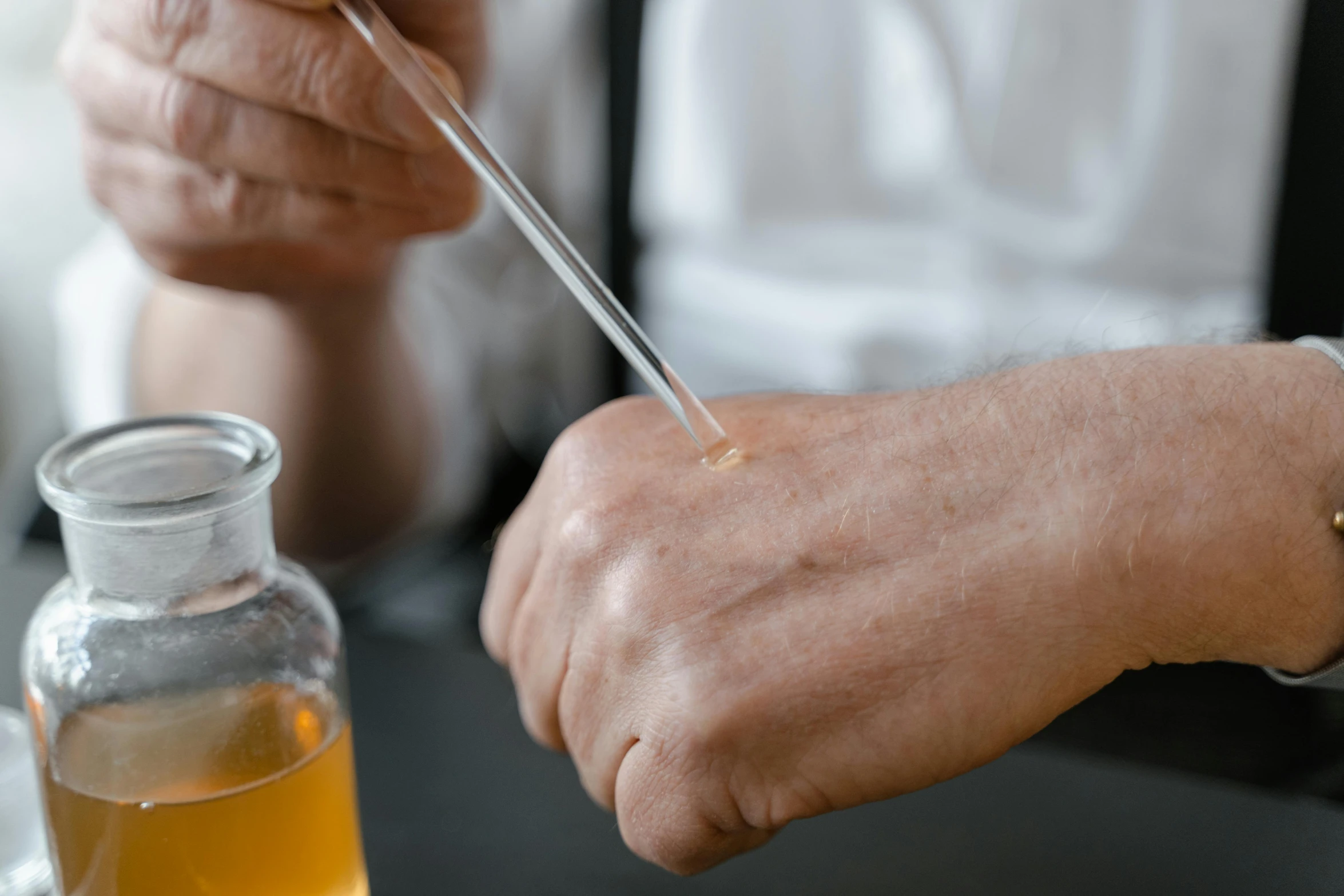 a close up of a person with a needle in their hand, cooking oil, profile image, skincare, alchemist lab