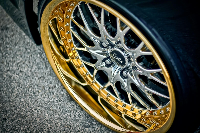 a close up of a gold rim on a black car, pexels contest winner, made of swiss cheese wheels, gtr xu1, flat colour, chrome plated