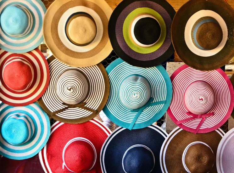 a bunch of hats sitting on top of a table, by Lee Loughridge, pexels contest winner, maximalism, concentric circles, summer color pattern, colombian, striped