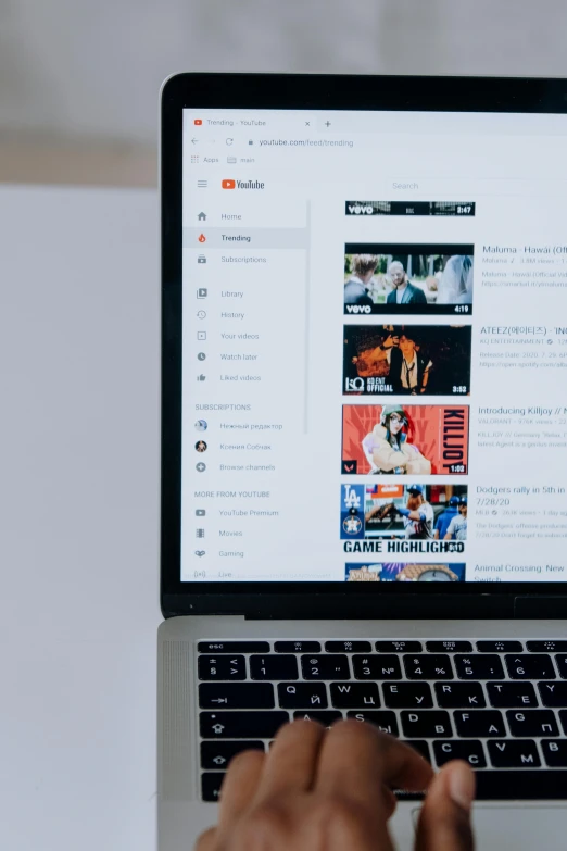 a person using a laptop computer on a table, a cartoon, trending on pexels, happening, youtube logo, high angle close up shot, on display, movie photo