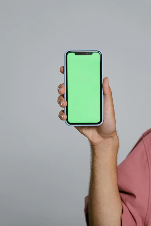 a man holding up a smart phone with a green screen, trending on pexels, square, spectral color, 16k resolution:0.8, no - text no - logo