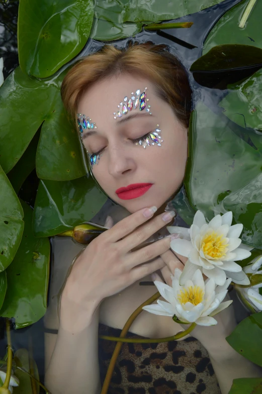 a close up of a person in a body of water with flowers, makeup, lily pads, photosynthetic, ilustration