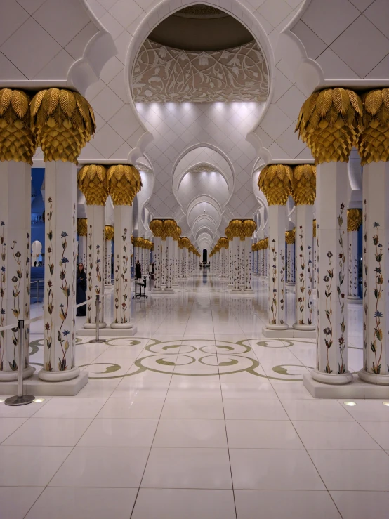 the inside of a large white and gold building, inspired by Sheikh Hamdullah, golden pillars, elegant walkways between towers, shiny lighting, taken in the late 2010s