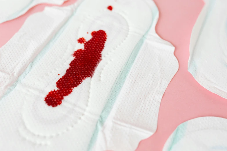 a close up of a piece of cloth with a blood stain on it, toiletpaper magazine, silicone patch design, bandages, crimson themed