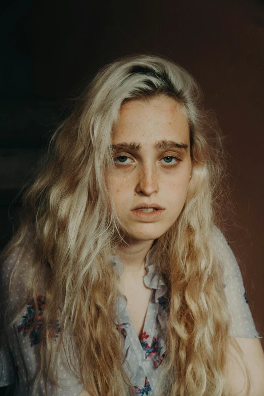 a close up of a person with long hair, inspired by Elsa Bleda, ugly look, frowning, curly blond, post grunge