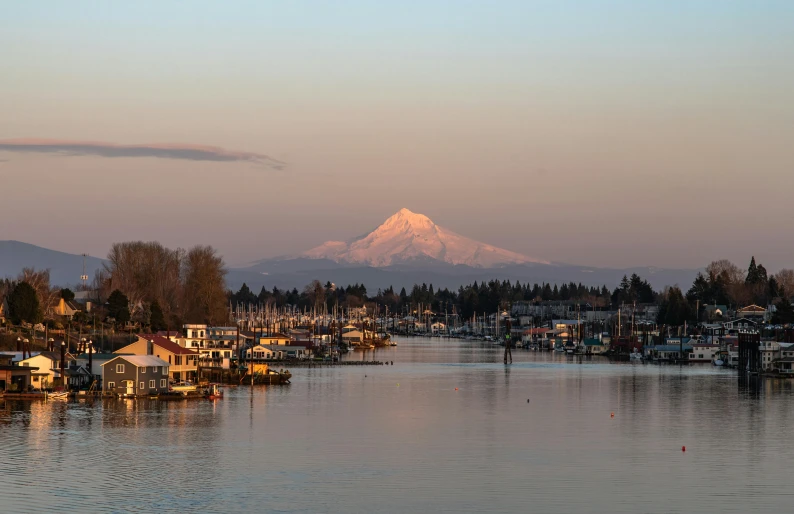 a large body of water with a mountain in the background, by Jim Nelson, pexels contest winner, ballard, upon a peak in darien, soft glow, with snow on its peak