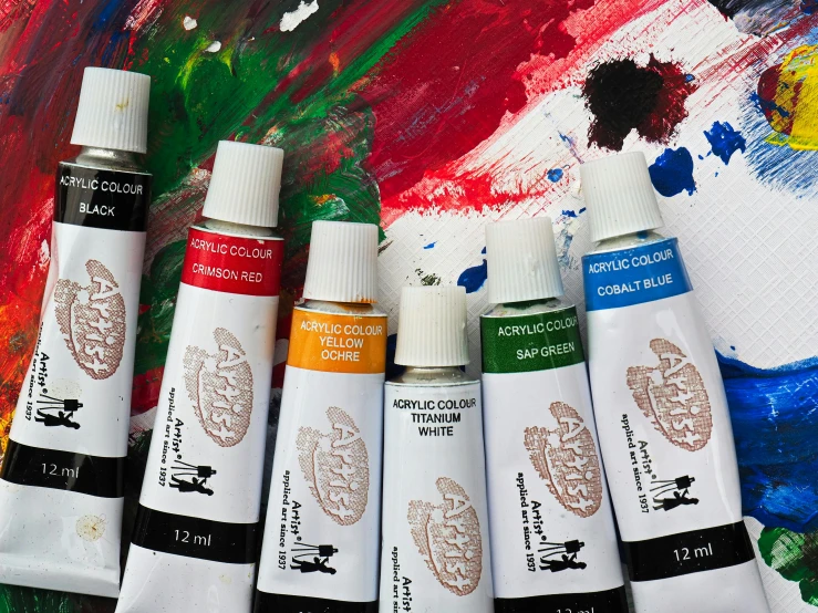 a group of paint tubes sitting on top of a table, an acrylic painting, pexels contest winner, ariel view, artemixel, multi colour, detailed product image