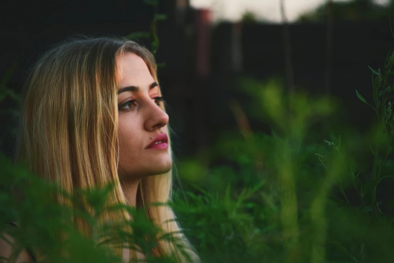 a woman that is standing in the grass, inspired by Elsa Bleda, pexels contest winner, realism, blonde and attractive features, distant thoughtful look, woman made of plants, prominent jawline