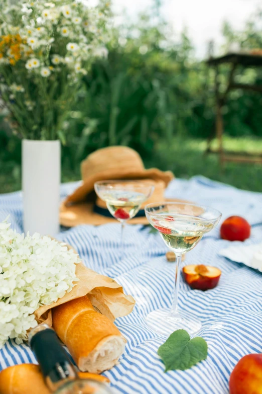 a table that has a bunch of food on it, a portrait, unsplash, summer field, bubbly, white, linen