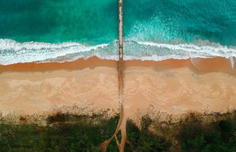 an aerial view of a beach and a pier, pexels contest winner, hurufiyya, kauai, half and half, brown, australia