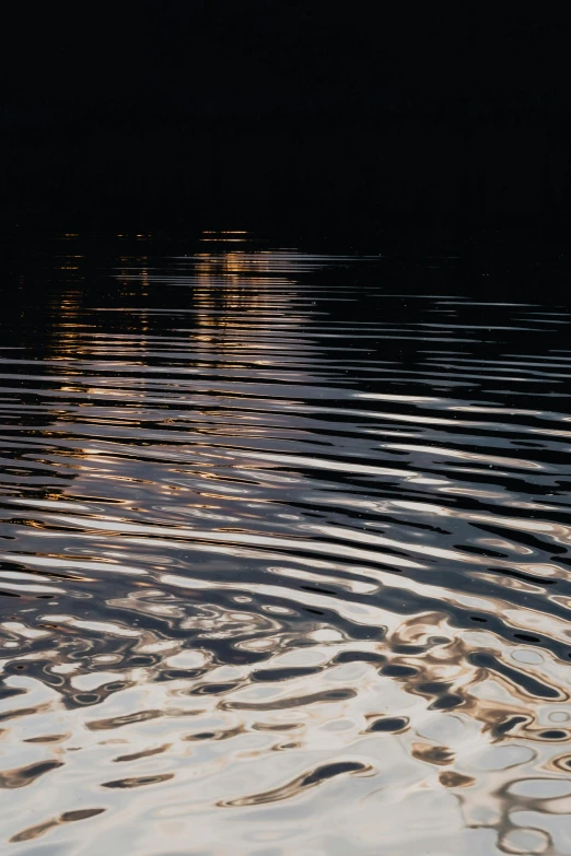 a close up of a body of water with a boat in the background, inspired by Andreas Gursky, unsplash, lyrical abstraction, dark golden light night, swirly ripples, detailed reflections, paul barson