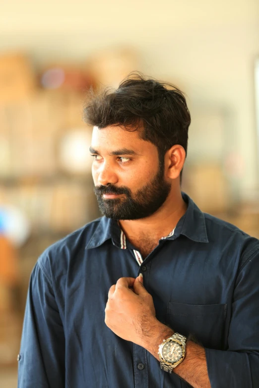 a man with a beard wearing a blue shirt, by Max Dauthendey, nivanh chanthara, cinematic image, casually dressed, icon