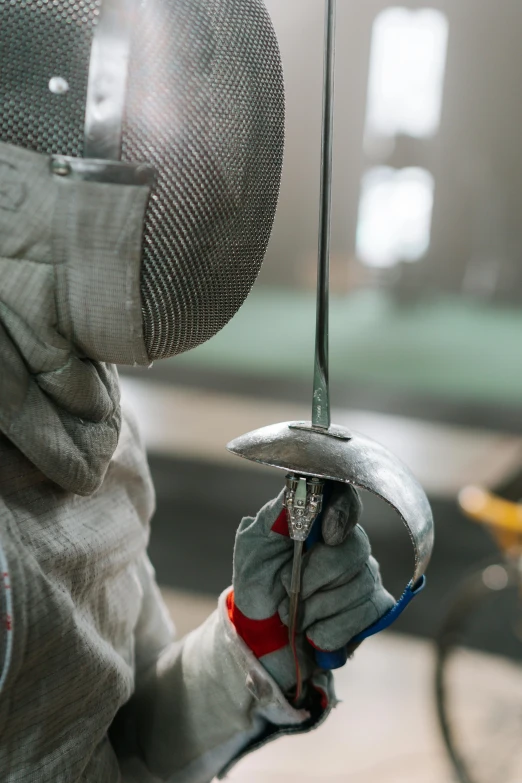 a fencer wearing a mask and holding a sword, pexels contest winner, metal hard surfaces, instagram story, manufacturing, silver space suit