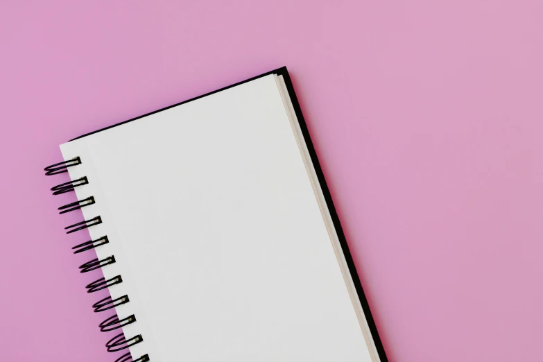a blank notebook on a pink background, by Robbie Trevino, trending on pexels, fan favorite, whiteboards, purple background, my pov
