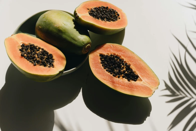 a couple of papanas sitting on top of a table, by Carey Morris, trending on unsplash, bowl of fruit, abundant fruition seeds, in shades of peach, set against a white background