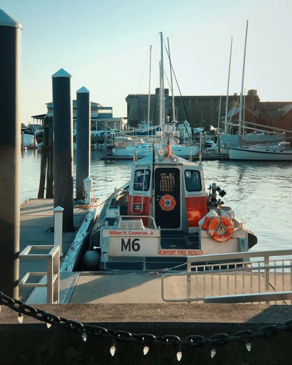 a boat that is sitting in the water, docked at harbor, trending on vsco, multiple stories, thumbnail