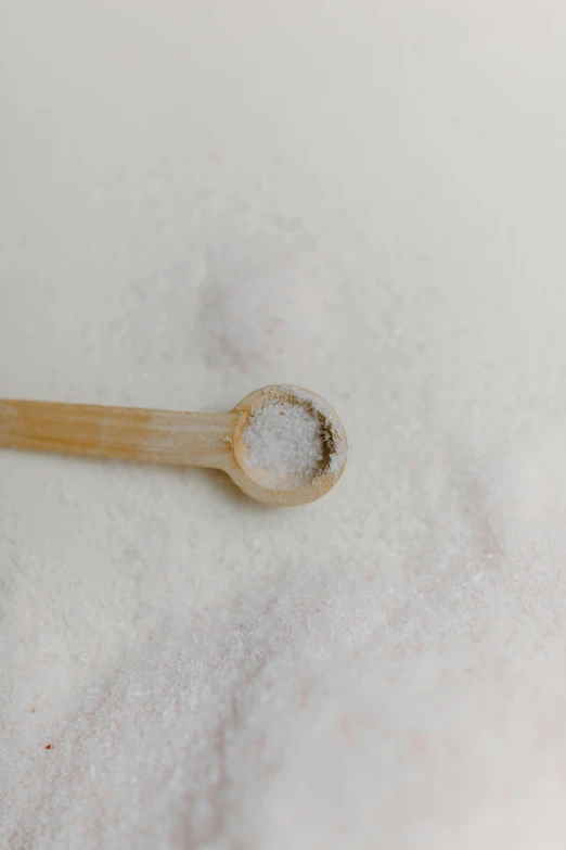 a wooden spoon sitting on top of a pile of sugar, unsplash, process art, detailed product image, sweat, white, ignant