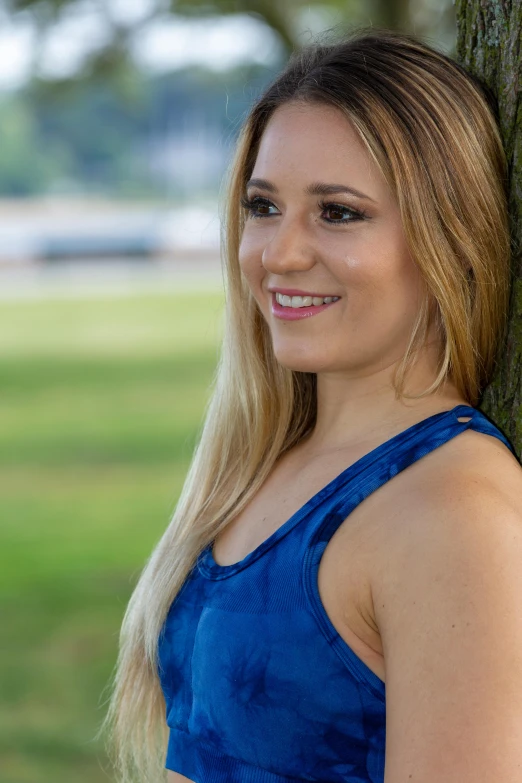 a woman leaning against a tree in a park, a portrait, by Sven Erixson, mandy jurgens 8 k 1 5 0 mpx, brazilian, square, long blonde hair and blue eyes