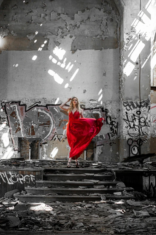 a woman in a red dress standing in an abandoned building, pexels contest winner, graffiti, dance, recital, standing atop a pile of rubble, instagram photo