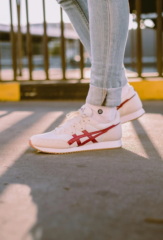 a person standing on a skateboard in front of a fence, by Austin English, trending on unsplash, renaissance, a woman wearing red high heels, off white, 15081959 21121991 01012000 4k, running shoes