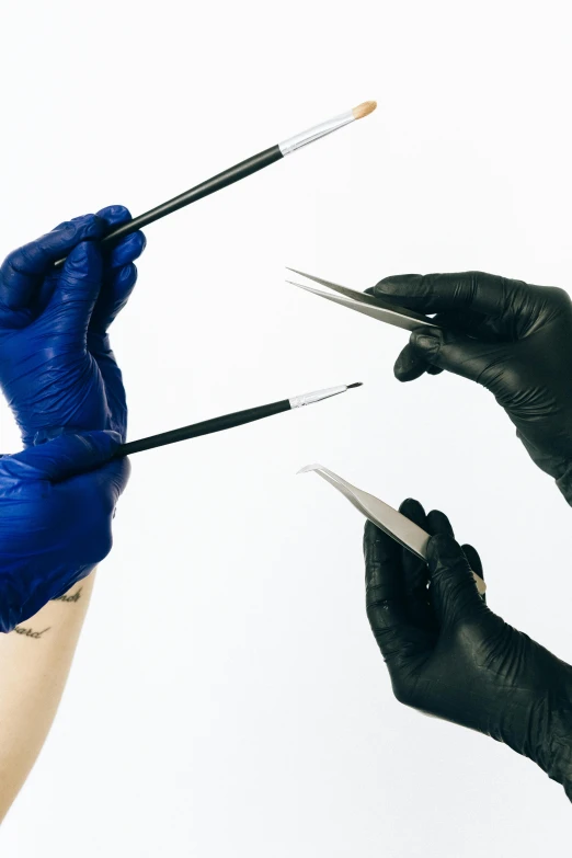 a person in black gloves holding a pair of scissors, an airbrush painting, shutterstock, hyperrealism, surgical implements, blue and black, wolfy nail, holding paintbrushes