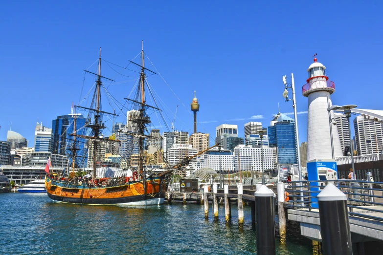 a boat in a body of water with a city in the background, inspired by Sydney Carline, pexels contest winner, hurufiyya, pirate ships, docked at harbor, three masts, straya