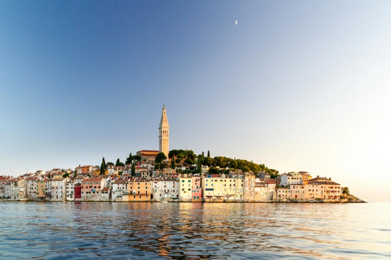 a group of buildings sitting on top of a body of water, by Matija Jama, pexels contest winner, romanticism, croatian coastline, soft glow, foil, slide show