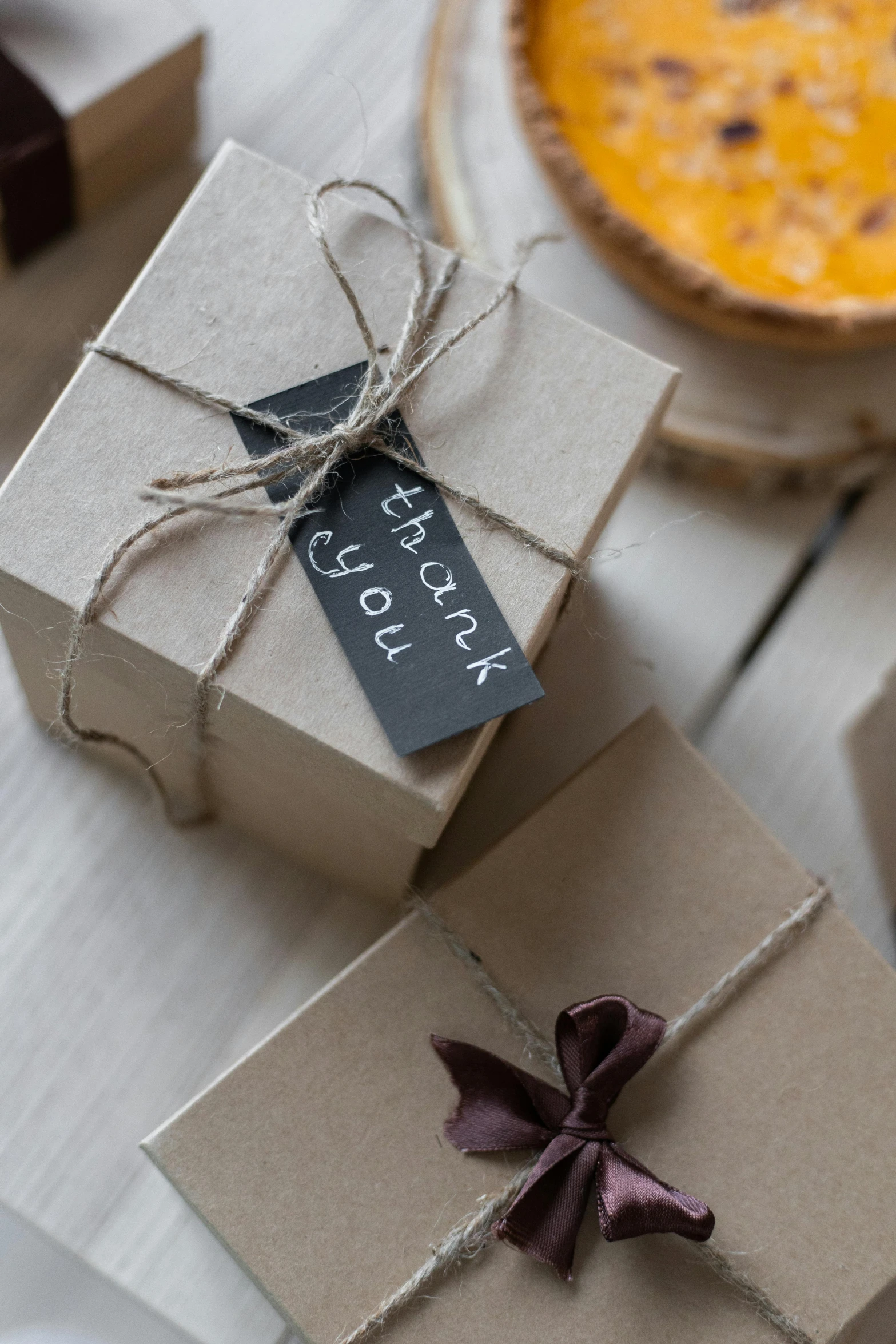 a couple of boxes sitting on top of a table, by Eden Box, autumnal, tag, bakery, thumbnail