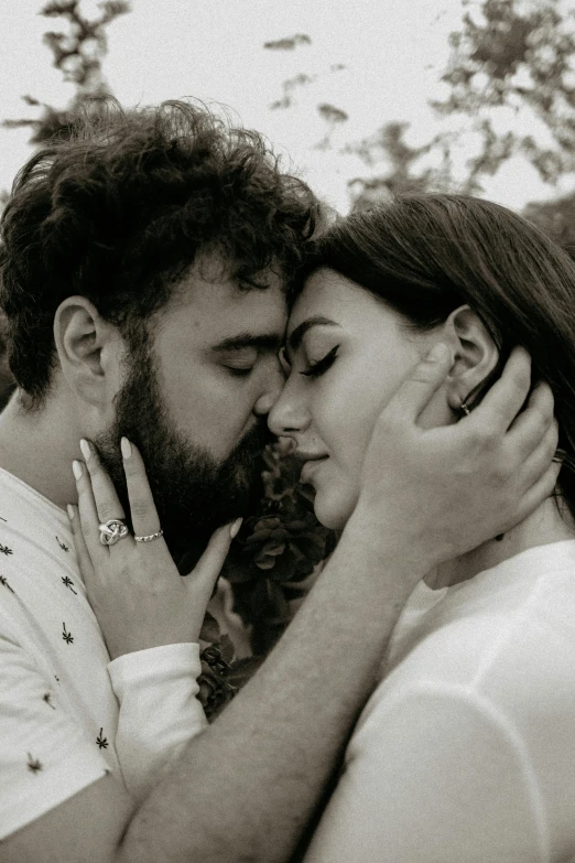 a black and white photo of a man kissing a woman, a black and white photo, pexels contest winner, serial art, charli xcx, post malone, bruce weber, wearing spiky