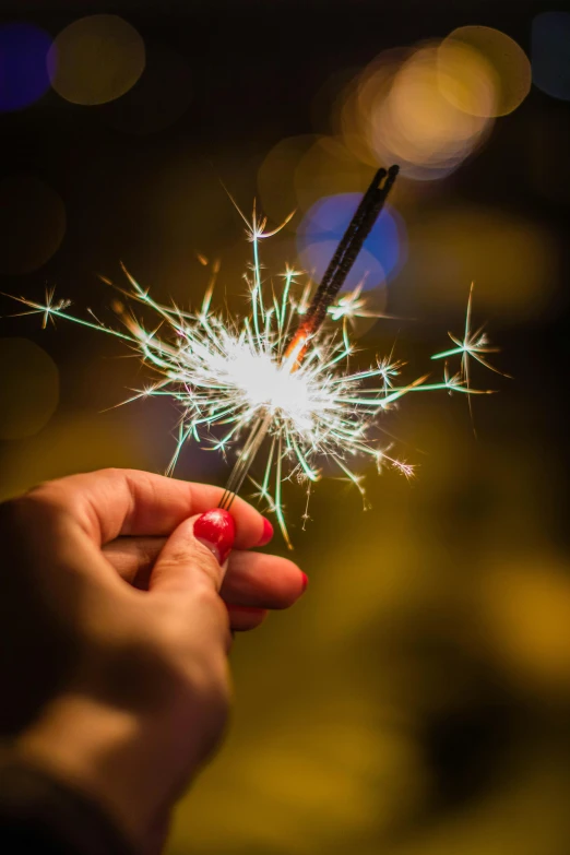 a person holding a sparkler in their hand, pexels, multiple stories, fan favorite, in 2 0 1 5, snacks