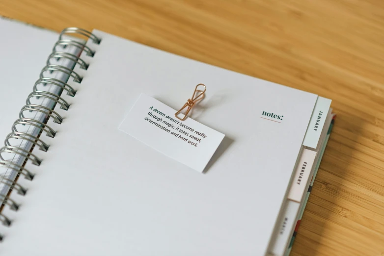 a notepad sitting on top of a wooden table, ( ( ( copper ) ) ) wire whiskers, labels, clear detailed view, 1/320