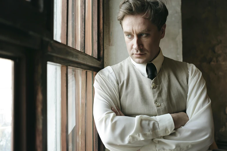 a man in a vest and tie leaning against a window, a portrait, inspired by William Mustart Lockhart, unsplash, renaissance, film promotional still, edward norton, dressed in an old white coat, danny fox and hilma af klint