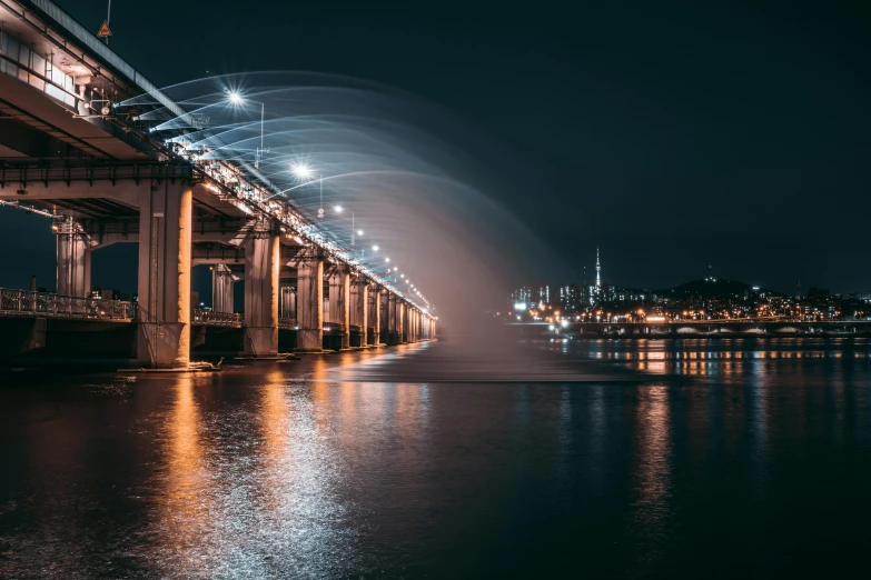 a bridge over a body of water at night, by Jang Seung-eop, unsplash contest winner, water jets, seoul, hyperdetailed, 2 0 2 2 photo