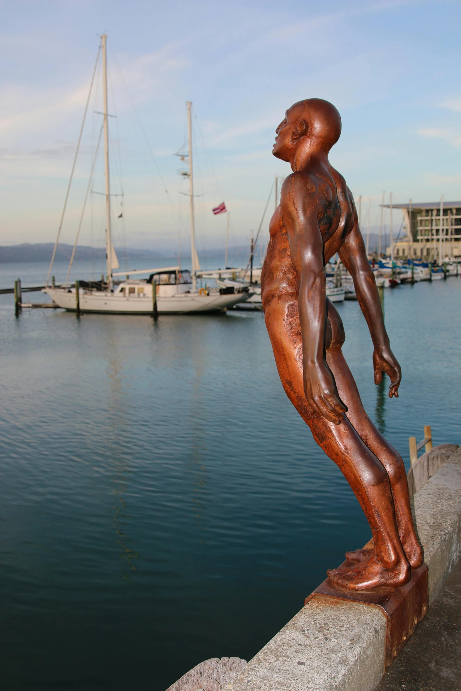 a statue of a man standing next to a body of water, pexels contest winner, new sculpture, docked at harbor, man is with black skin, anatomically correct body, new zealand