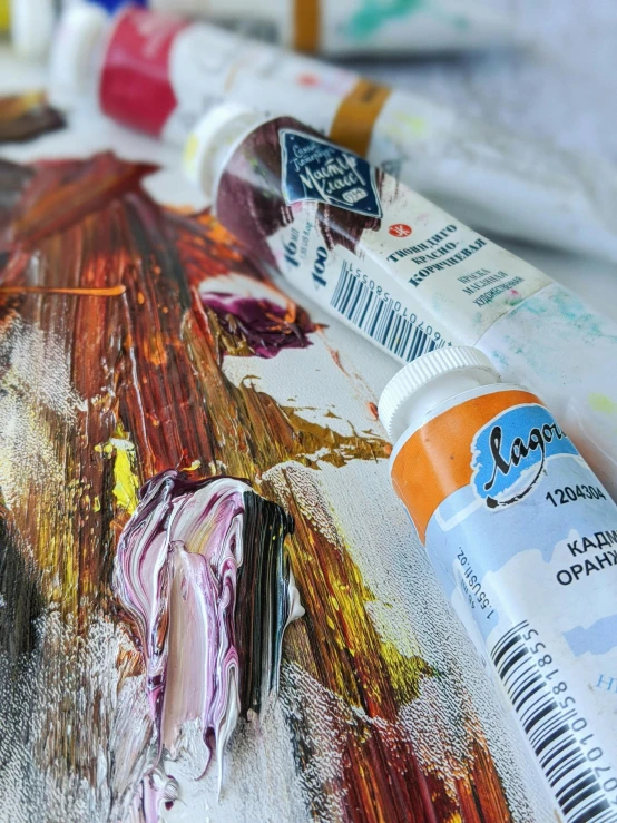 a close up of a piece of art on a table, inspired by Jean-Baptiste van Loo, pexels contest winner, white and orange, paint tubes, afremov leonid, ilustration