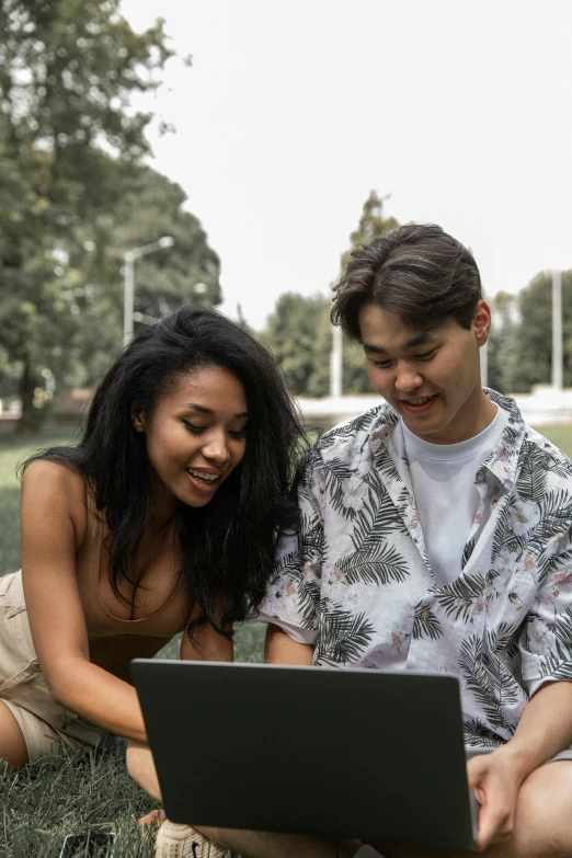 a man and woman sitting on the grass looking at a laptop, trending on pexels, renaissance, half asian, wearing a crop top, gif, proud looking