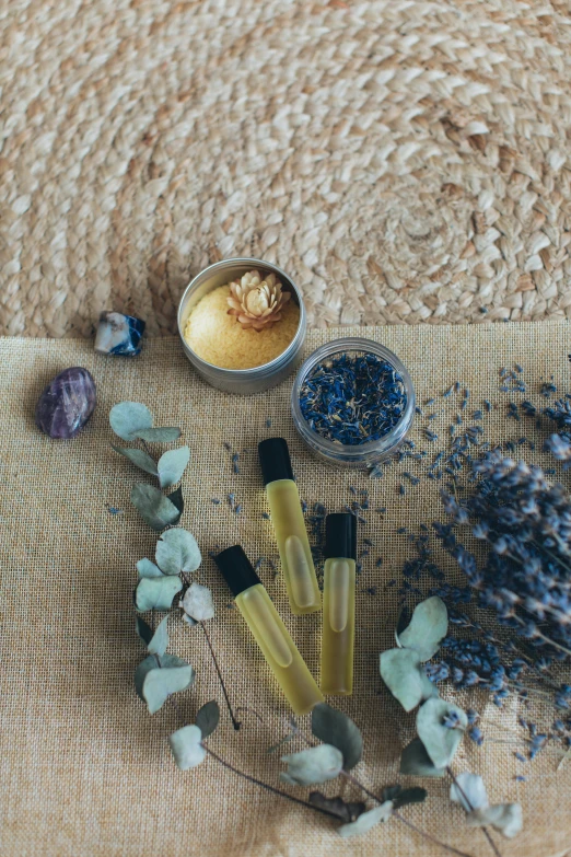 a bunch of flowers sitting on top of a table, skincare, gold and indigo, intricate oil sweeps, lavender