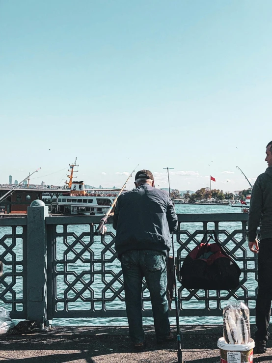 a couple of men standing next to each other on a bridge, pexels contest winner, hurufiyya, fish seafood markets, fallout style istanbul, background image