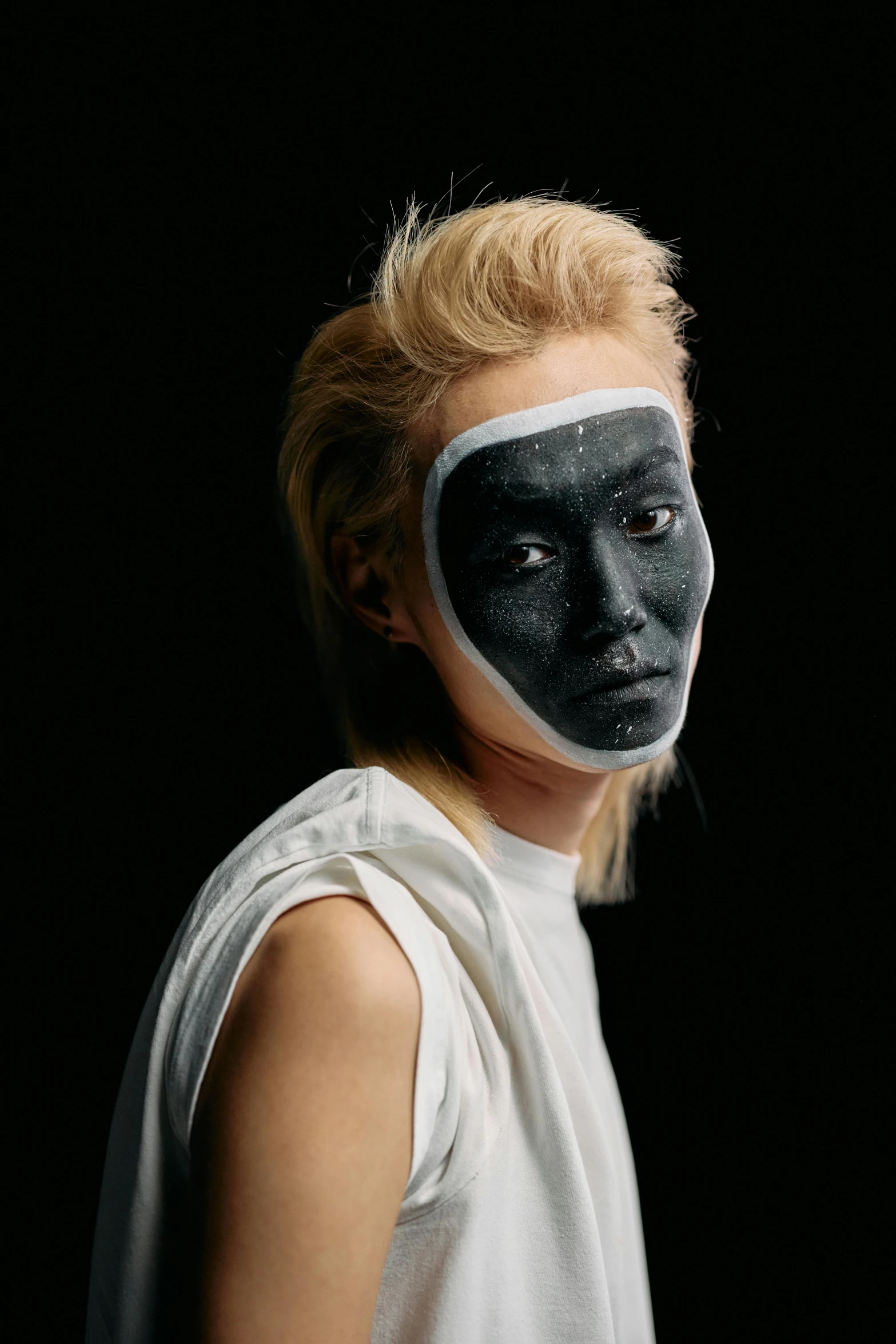 a woman with black paint on her face, an album cover, with a white complexion, wearing facemask, frown fashion model, jisu choe