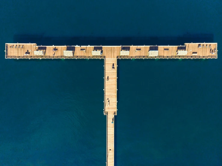 a pier in the middle of a large body of water, a digital rendering, pexels contest winner, hurufiyya, birdseye view, picton blue, zoomed in shots, corona renderer