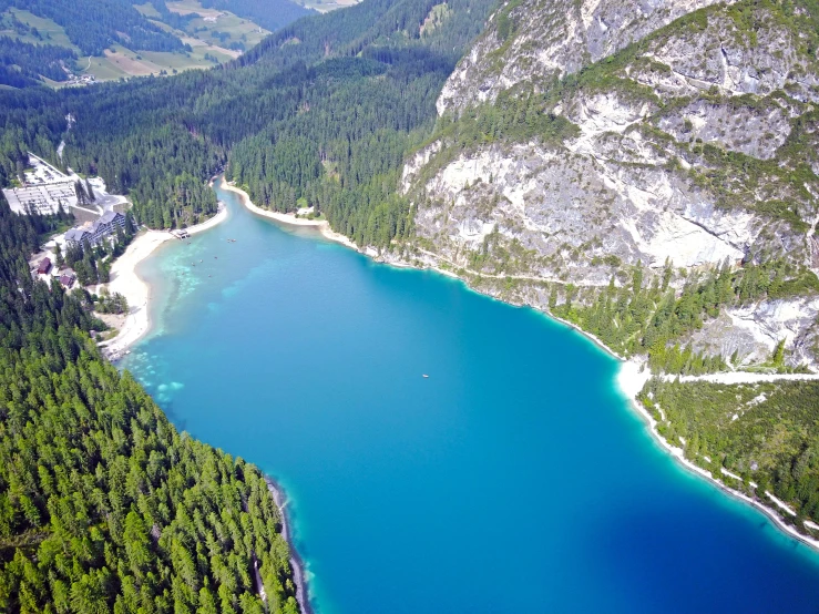 a large body of water surrounded by trees, pexels contest winner, dolomites, blue and green water, aerial footage, 2000s photo